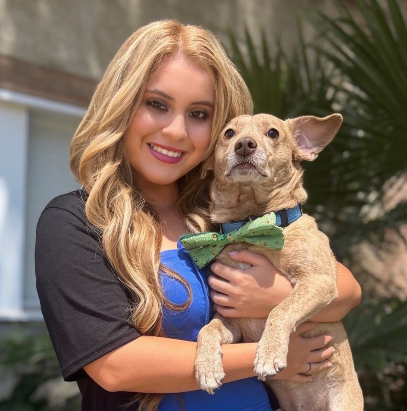 Jasmin holding Lucky, her rescue dog